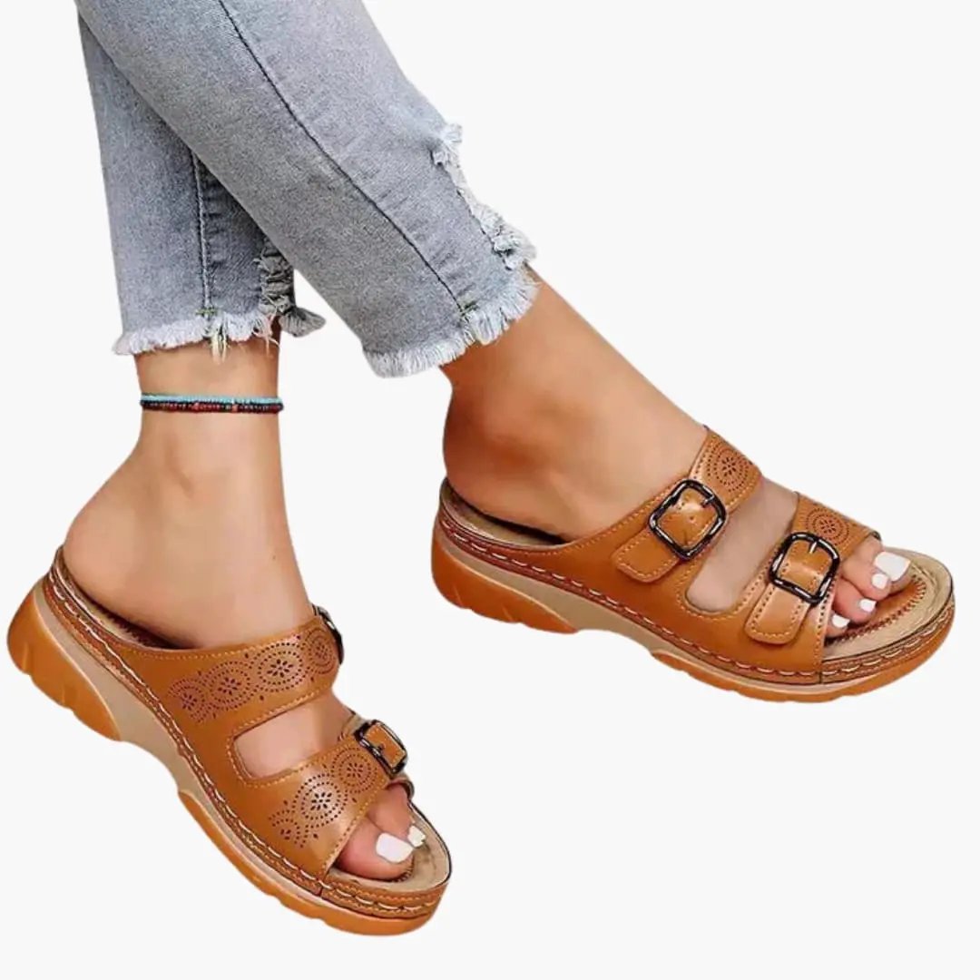 Pair of women's orthopedic sandals with adjustable straps and wedge sole in tan brown leather.