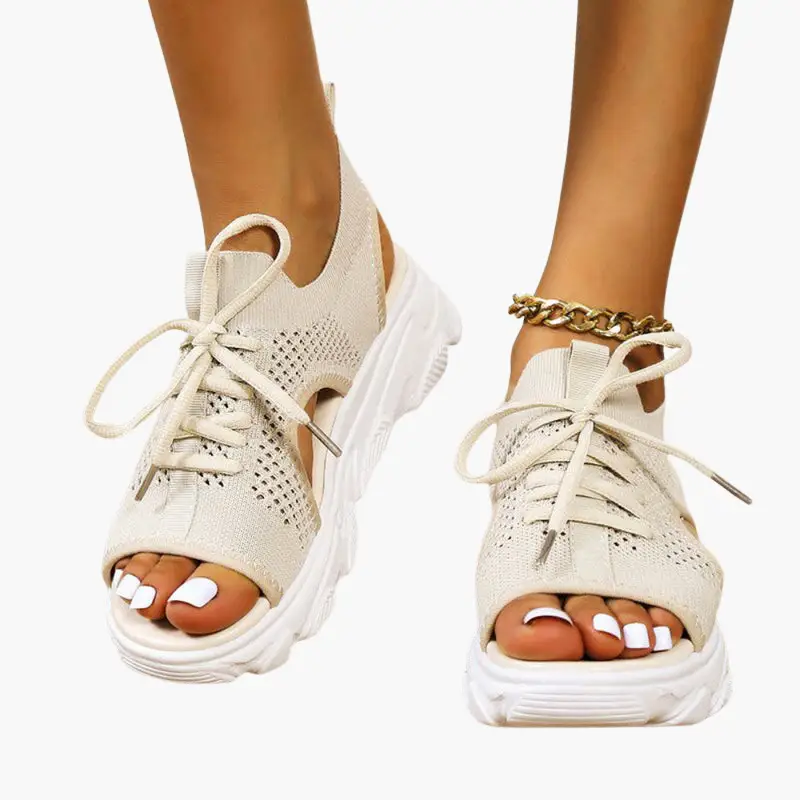 Pair of women's orthopedic sandals with beige knit upper, open-toe, cushioned footbed, and adjustable lace-up straps