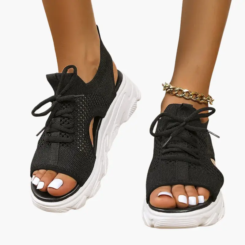 Pair of Wilfred Smith women’s orthopedic sandals with cushioned footbed, black knit upper, adjustable lace straps.