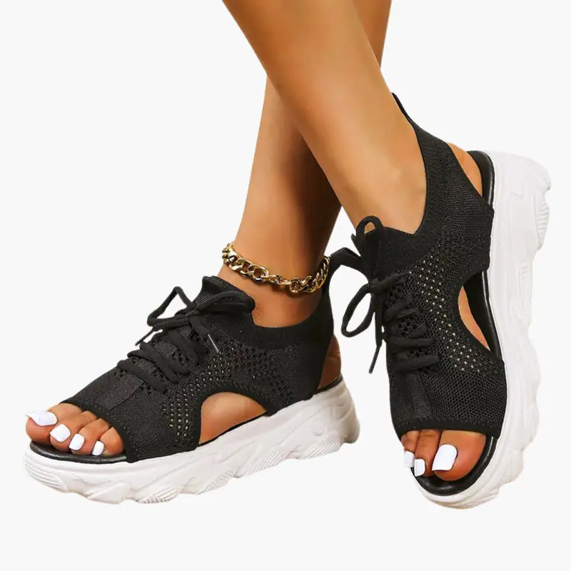 Women's orthopedic sandals with cushioned footbed, black knit upper, adjustable straps, white sole.