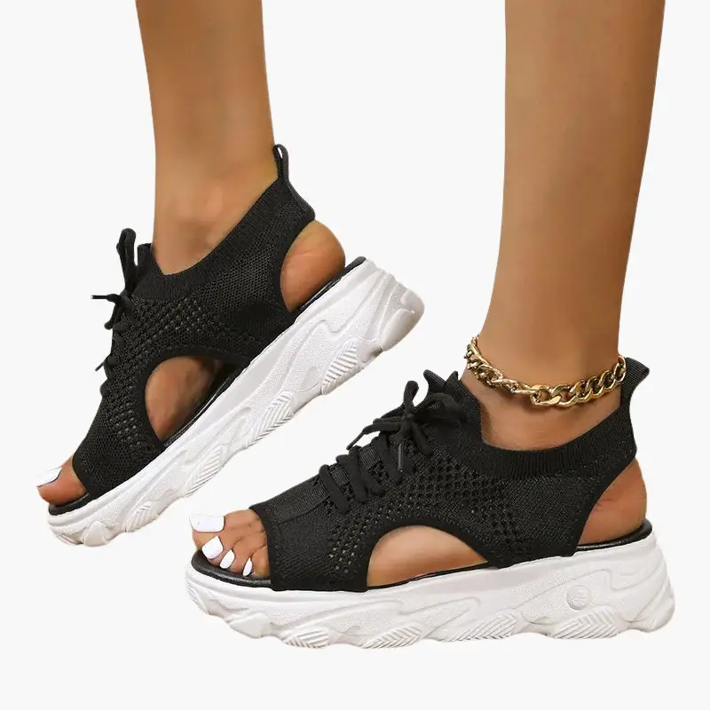 Pair of women's orthopedic sandals in black with cushioned footbed and adjustable straps, knit upper