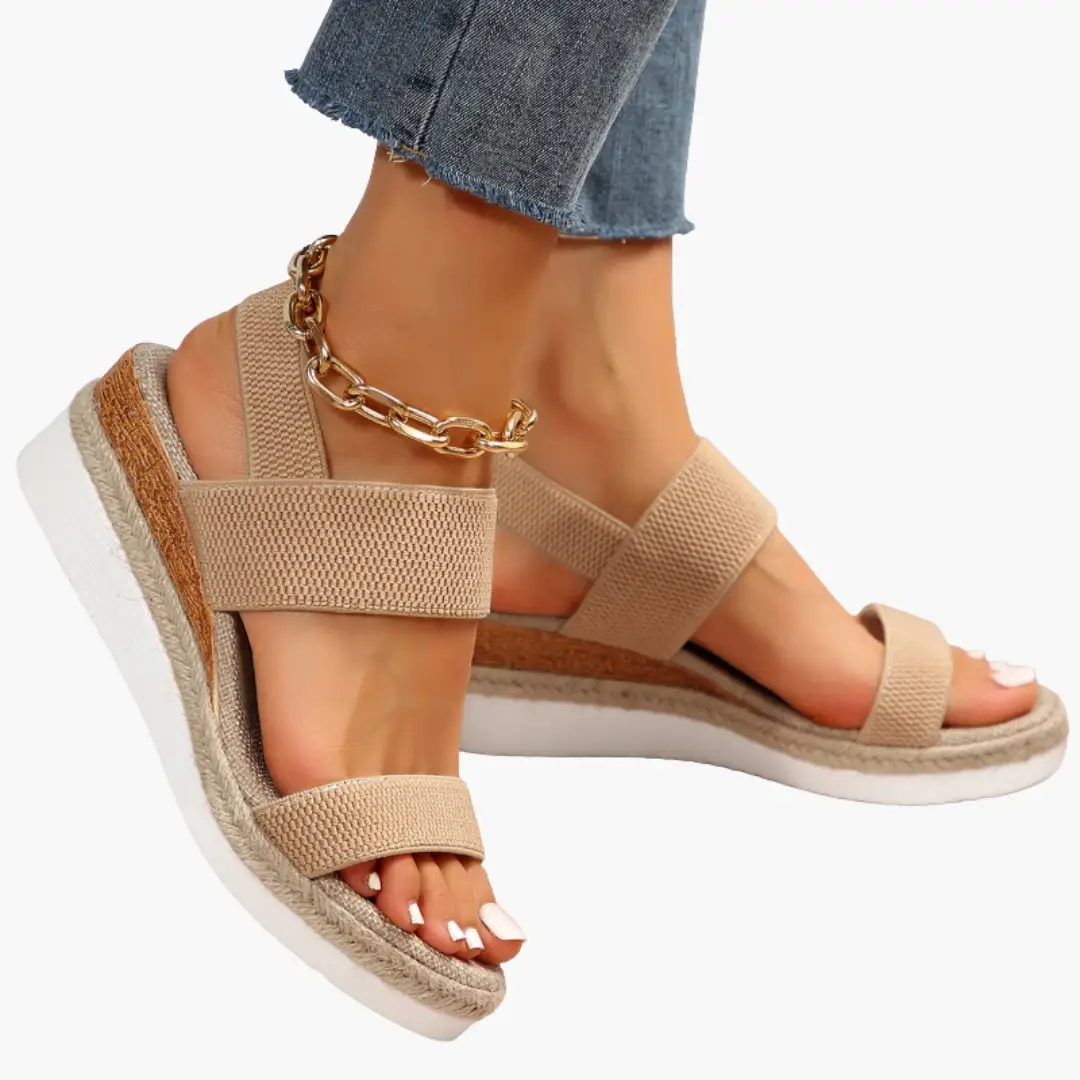 Women's orthopedic sandals with cushioned sole and adjustable beige straps; cork midsole and white outsole.