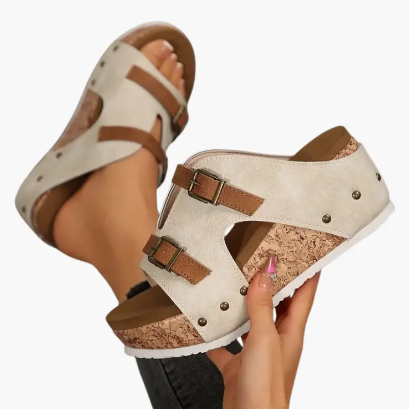 Pair of women's orthopedic sandals with wedge cork sole, beige suede upper and adjustable brown straps by Wilfred Smith