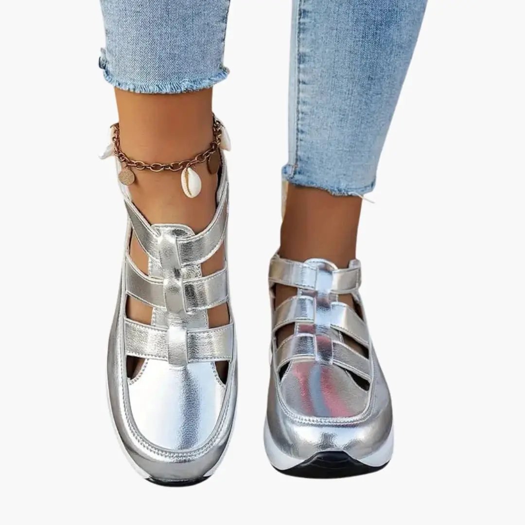 Pair of women's orthopedic sandals, silver metallic with adjustable straps and textured sole