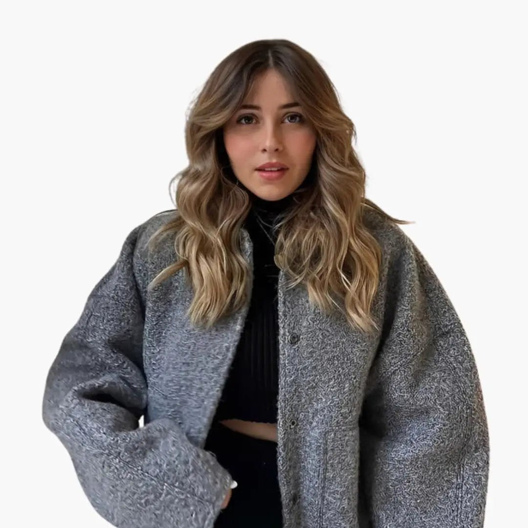 Women's oversized gray bomber jacket with front snap buttons, worn by model