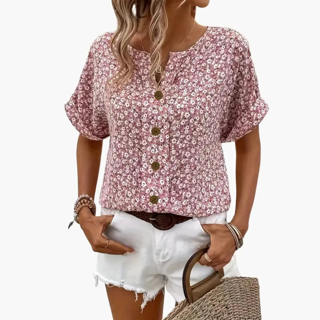 Women’s printed button-down blouse with pink floral pattern and loose fit, rolled sleeves