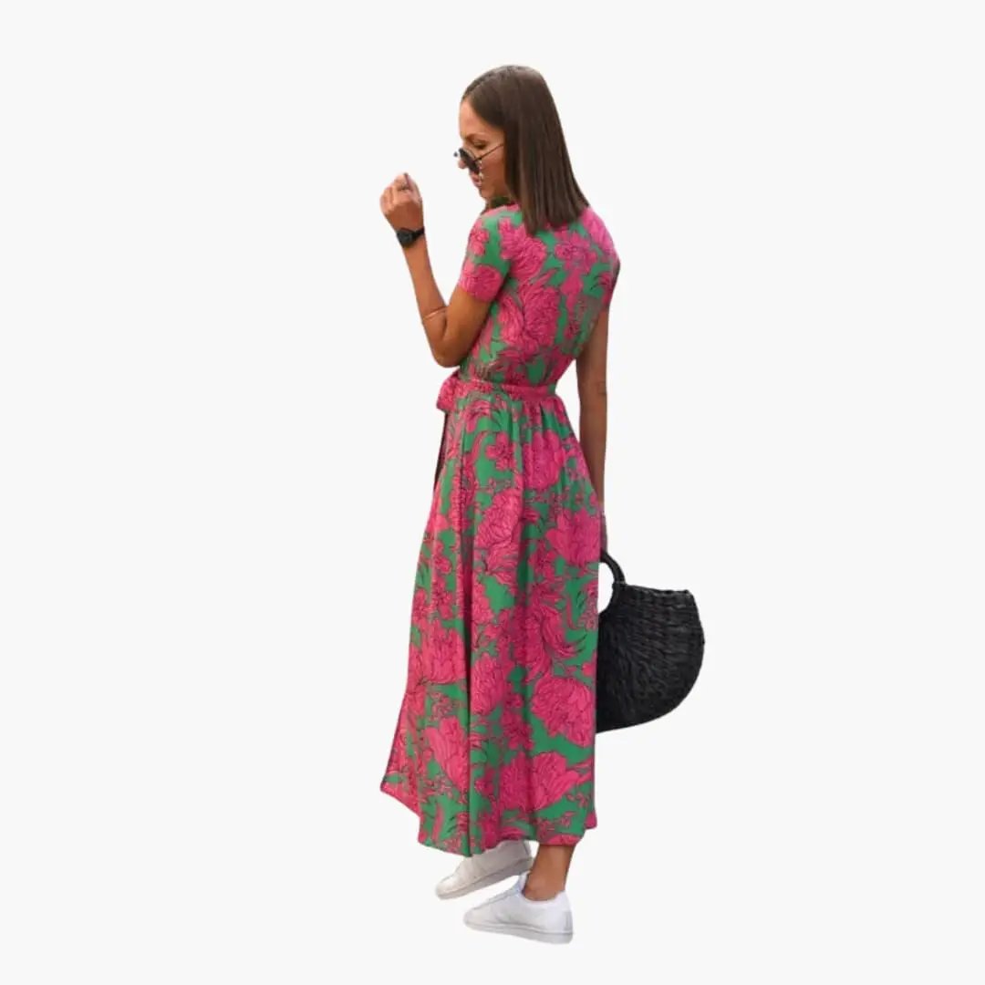 Women’s printed wrap dress with waist belt; pink floral on green, midi-length.