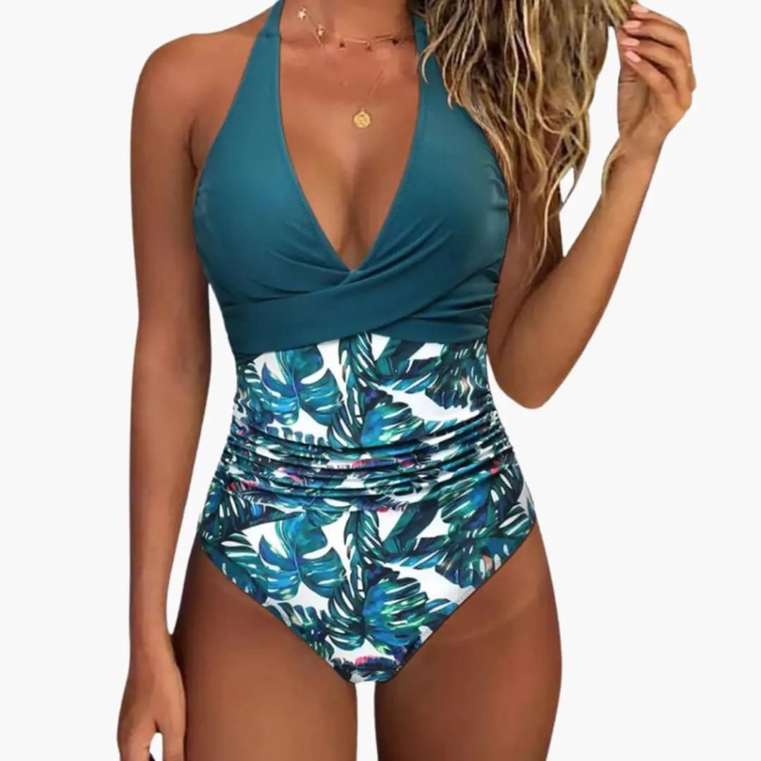 Women's push-up one-piece swimsuit with teal adjustable halter top and tropical leaf-print ruched bottom