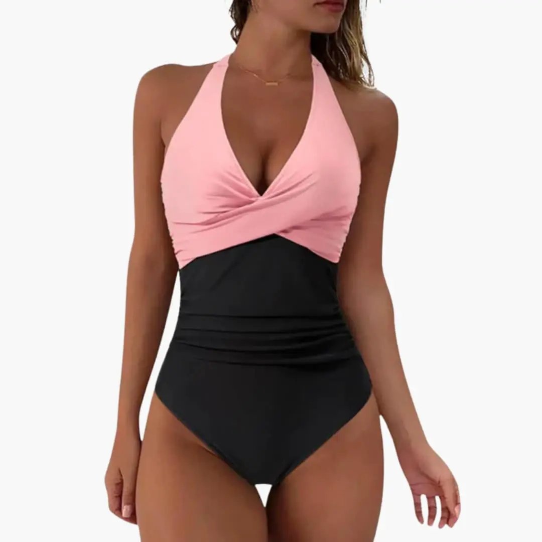 Women's push-up one-piece swimsuit by Wilfred Smith, pink halter-top with twist-front and black bottom