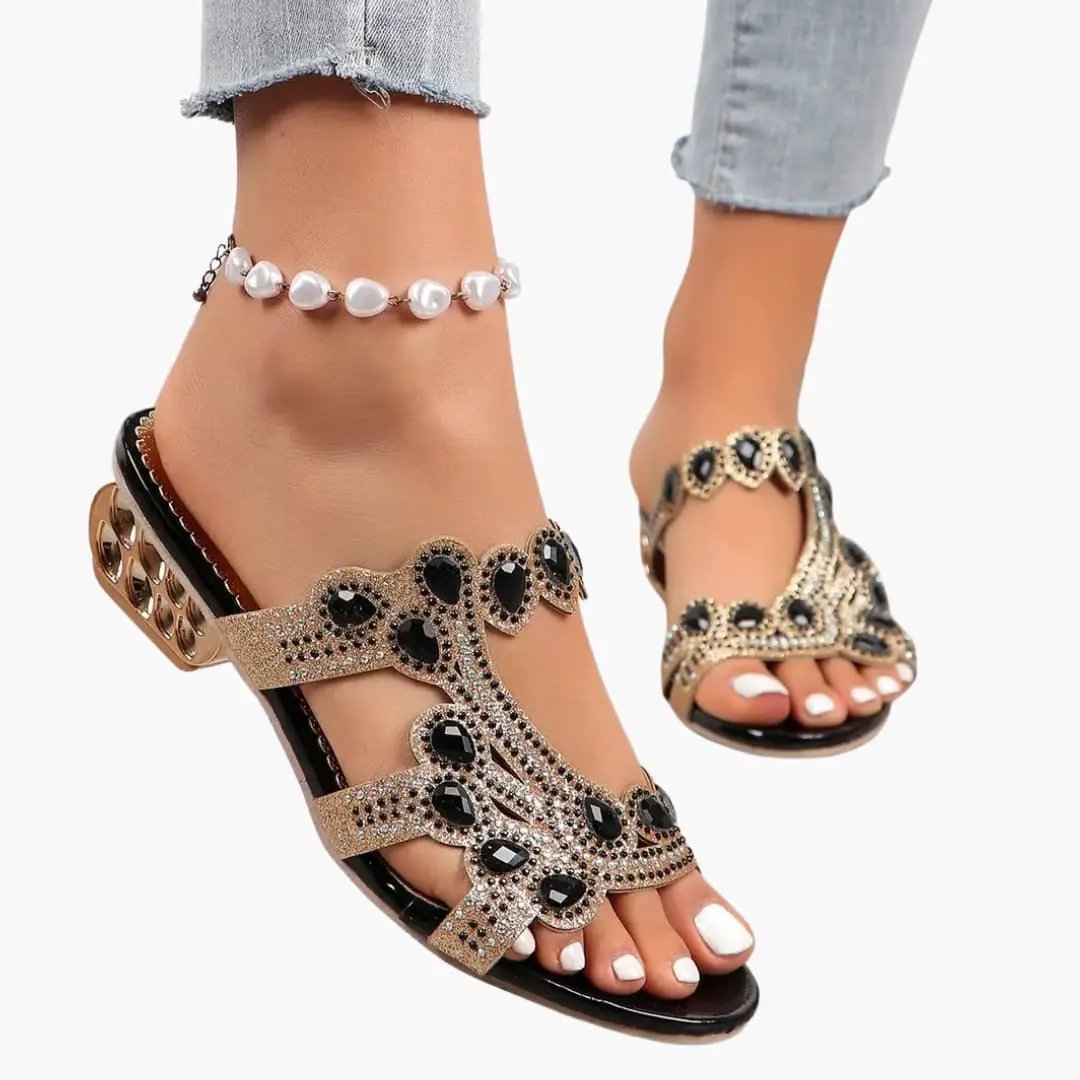 Women's sandals with adjustable straps and embellished upper; gold-tone with black stone accents.