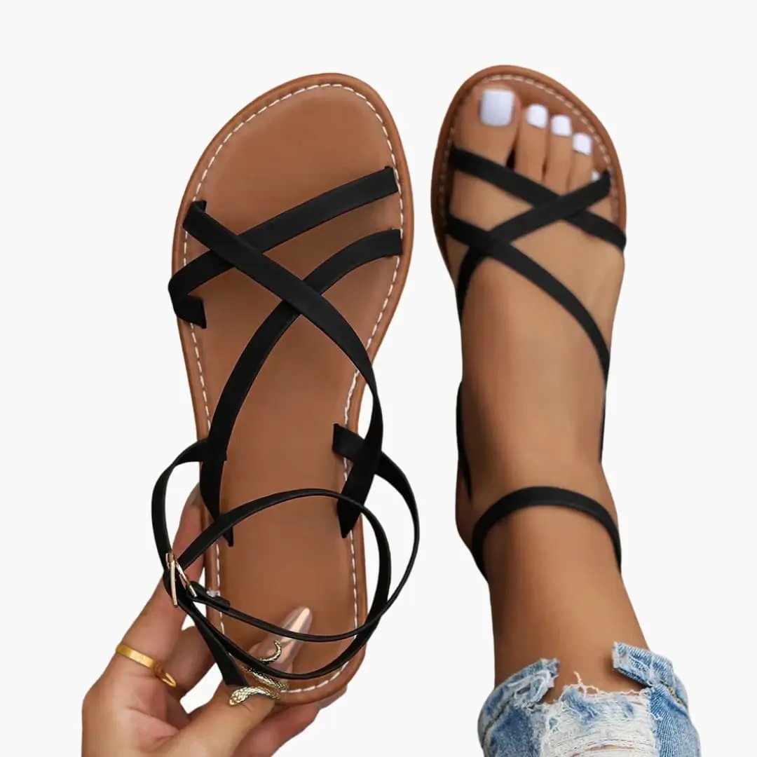Wilfred Smith women's sandals pair with crisscross black straps and adjustable ankle strap, tan footbed