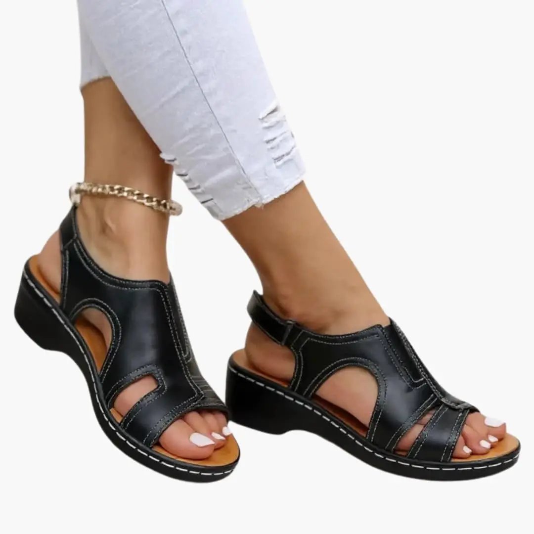 Women's black leather sandals with cushioned insole and adjustable slingback strap, open-toe low wedge heel