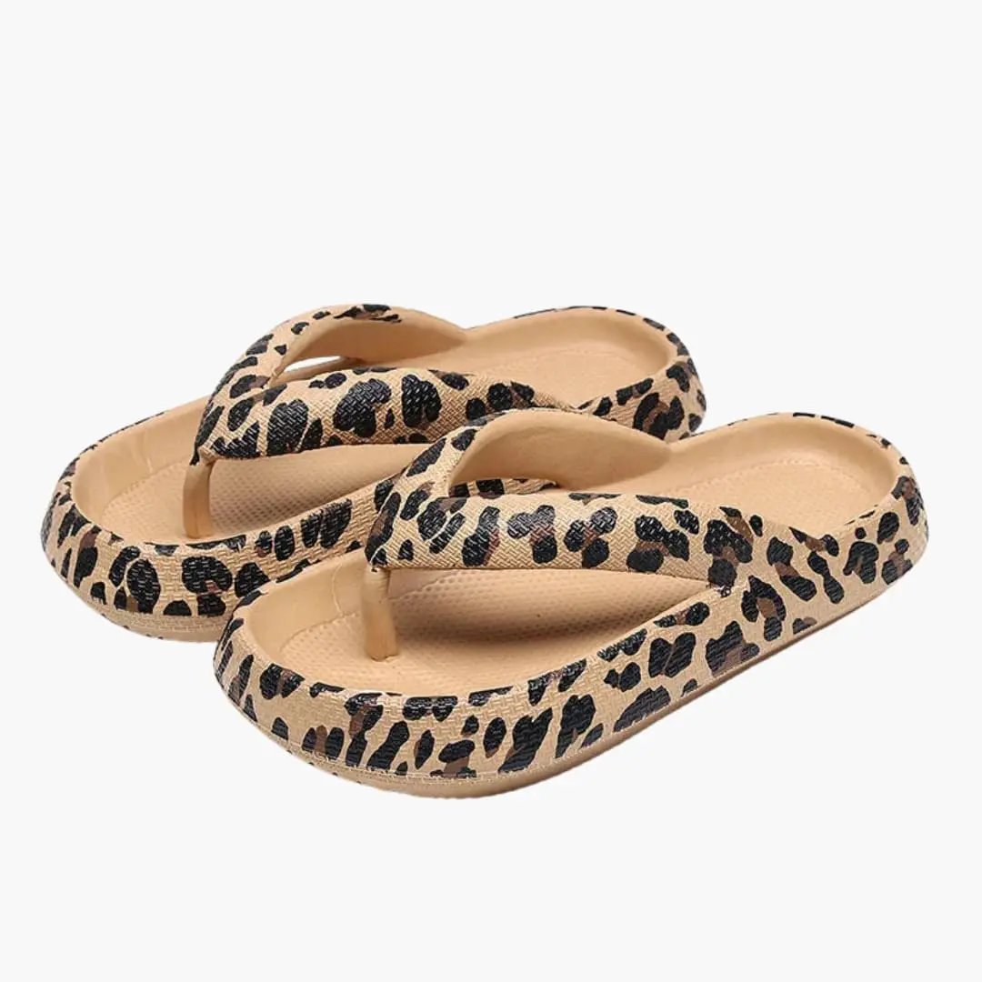 Pair of women's sandals by Wilfred Smith with cushioned sole and contoured footbed, leopard print straps.