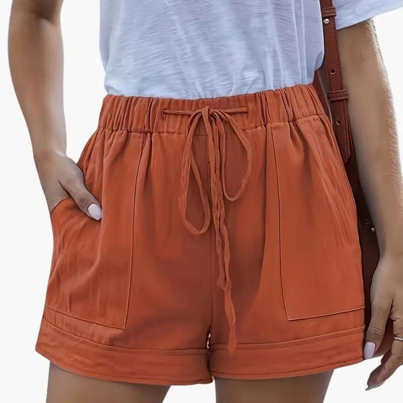 Women's jogger shorts by Wilfred Smith with drawstring waistband in orange, relaxed fit with front pockets.