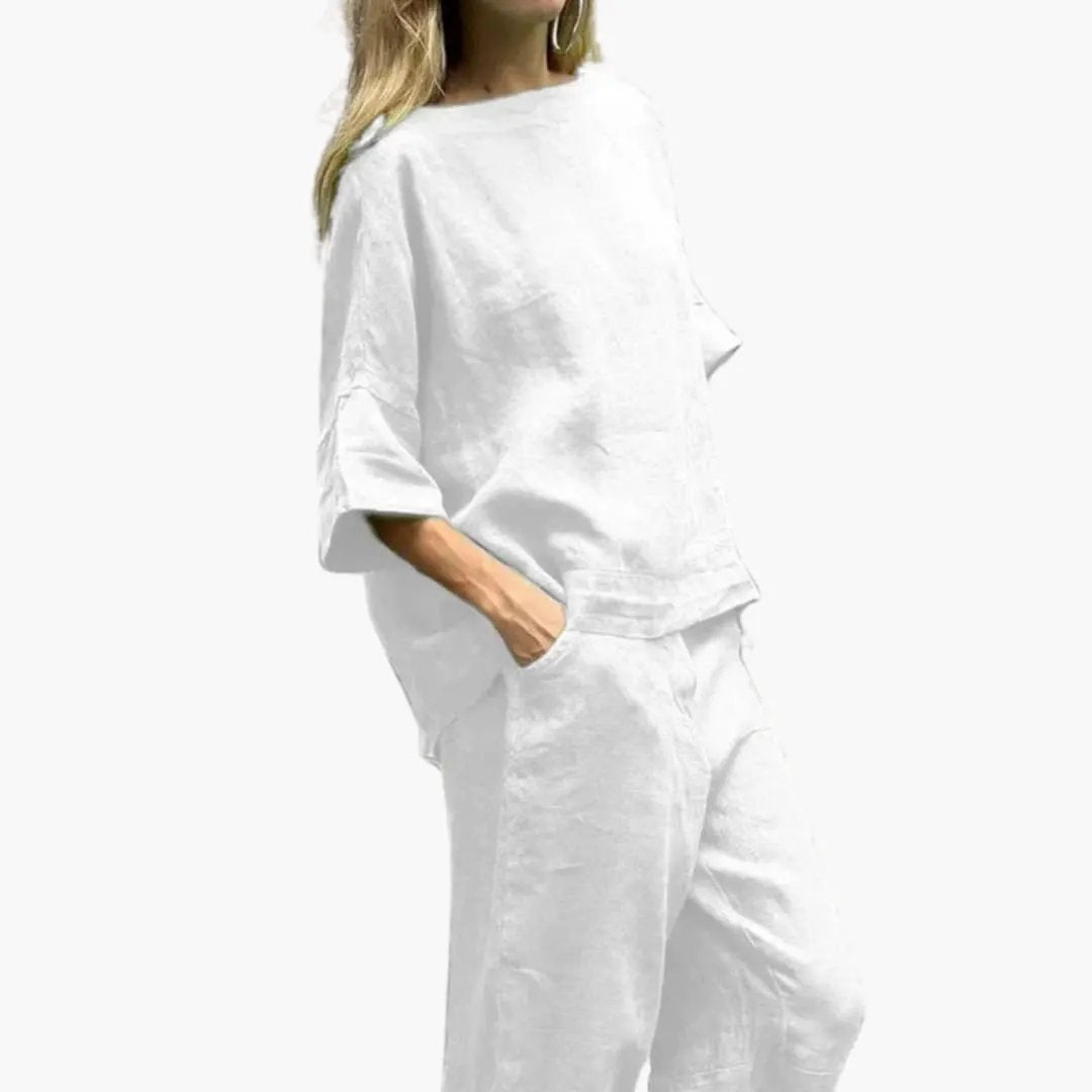 Women's two-piece white crop top and cropped pants outfit with a loose-fit top and pockets
