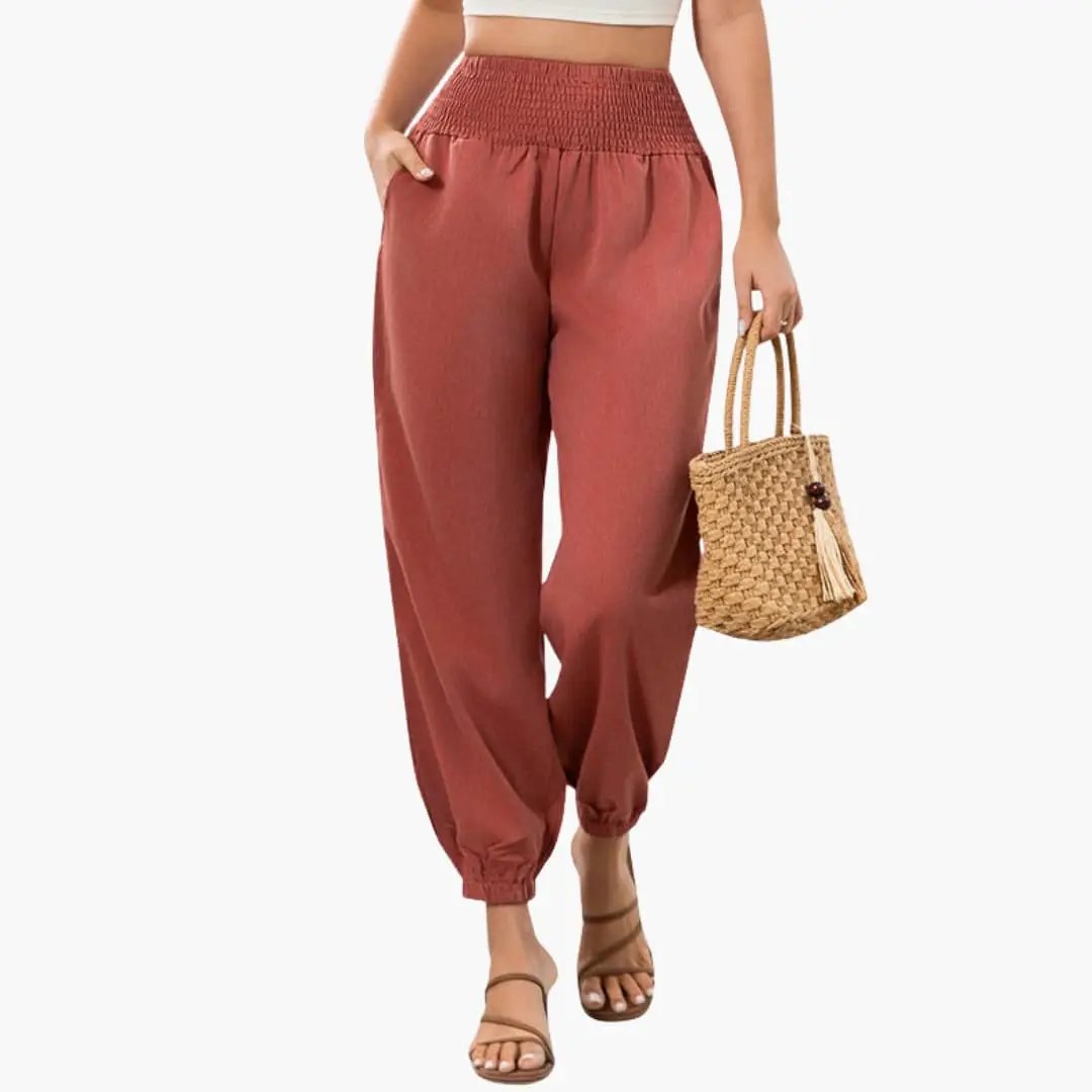 Women’s Summer Pants with Elastic Waist and Wide Leg in rust color, worn with a woven straw bag.