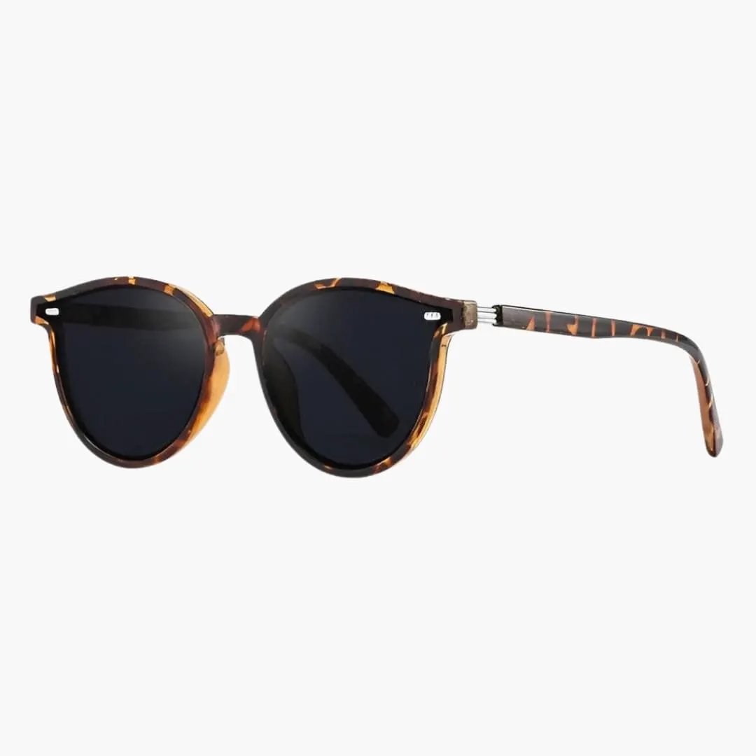 Women's sunglasses with tortoiseshell full-rim frame and dark lenses by Wilfred Smith