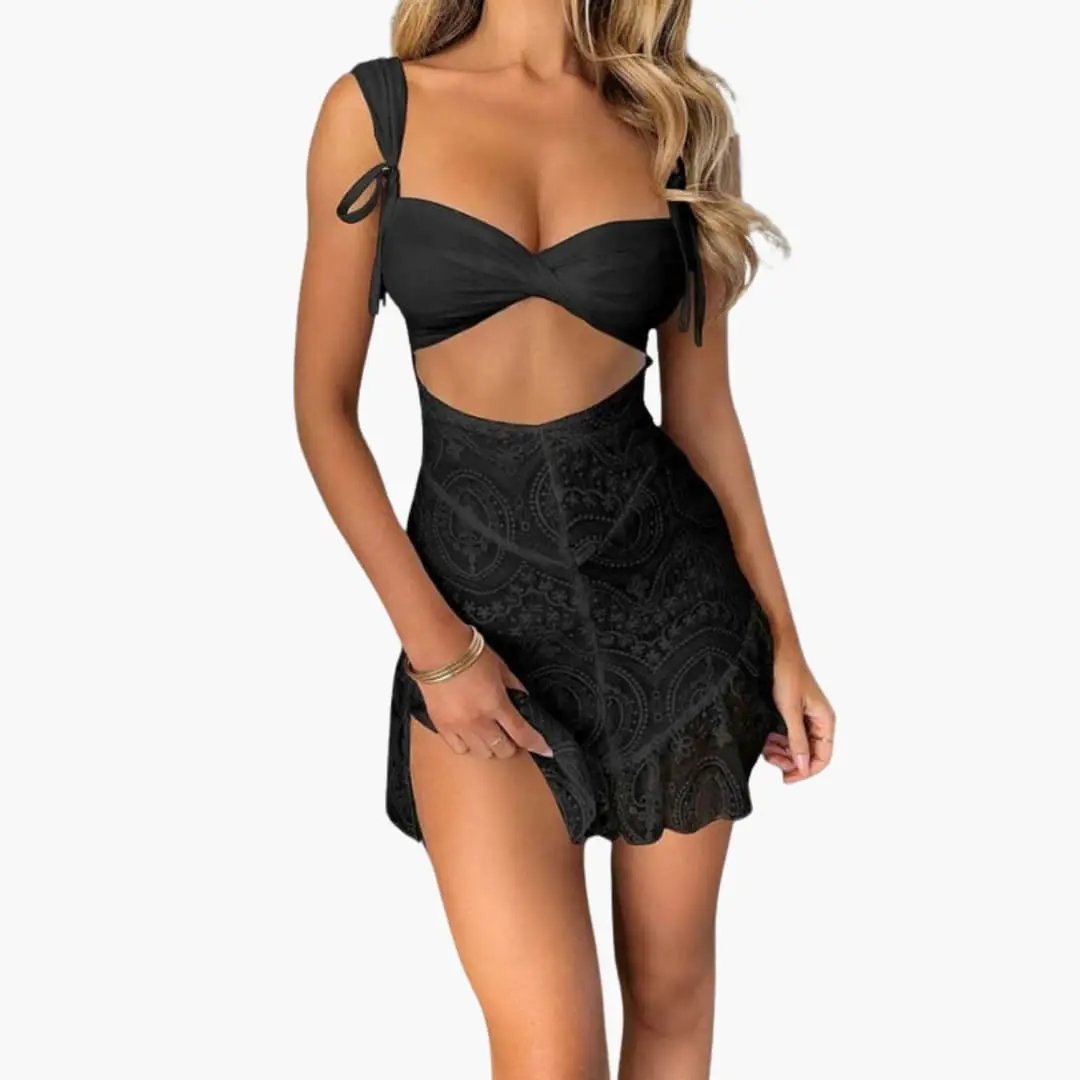 Women's two-piece black set with twist-front top and high-waisted paisley-print skirt.