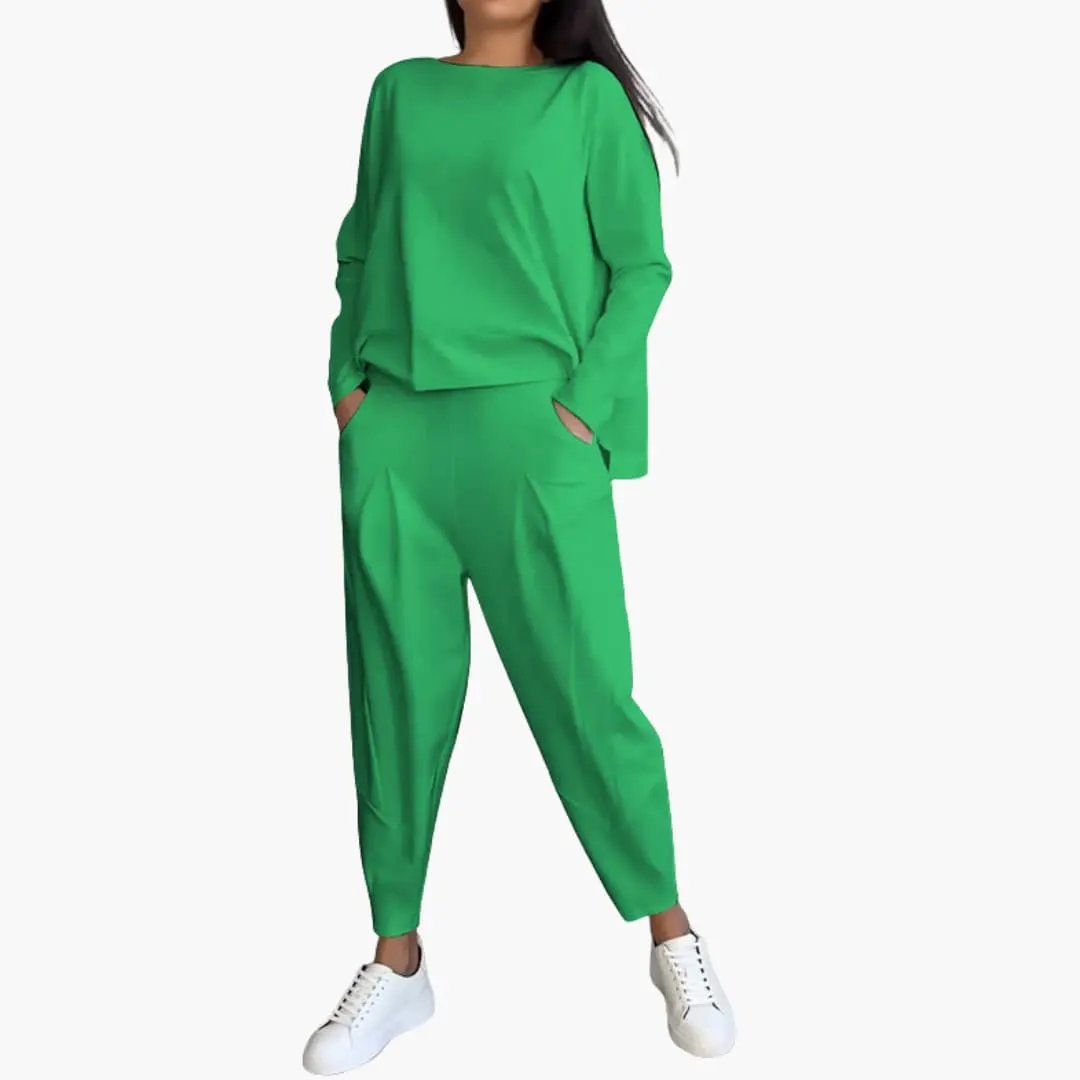 Women's two-piece outfit in bright green with a round-neck long-sleeve top and matching trousers with pockets.