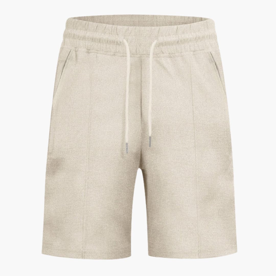 Women's beige waffle-textured shorts with elastic waistband, white drawstring, and pockets