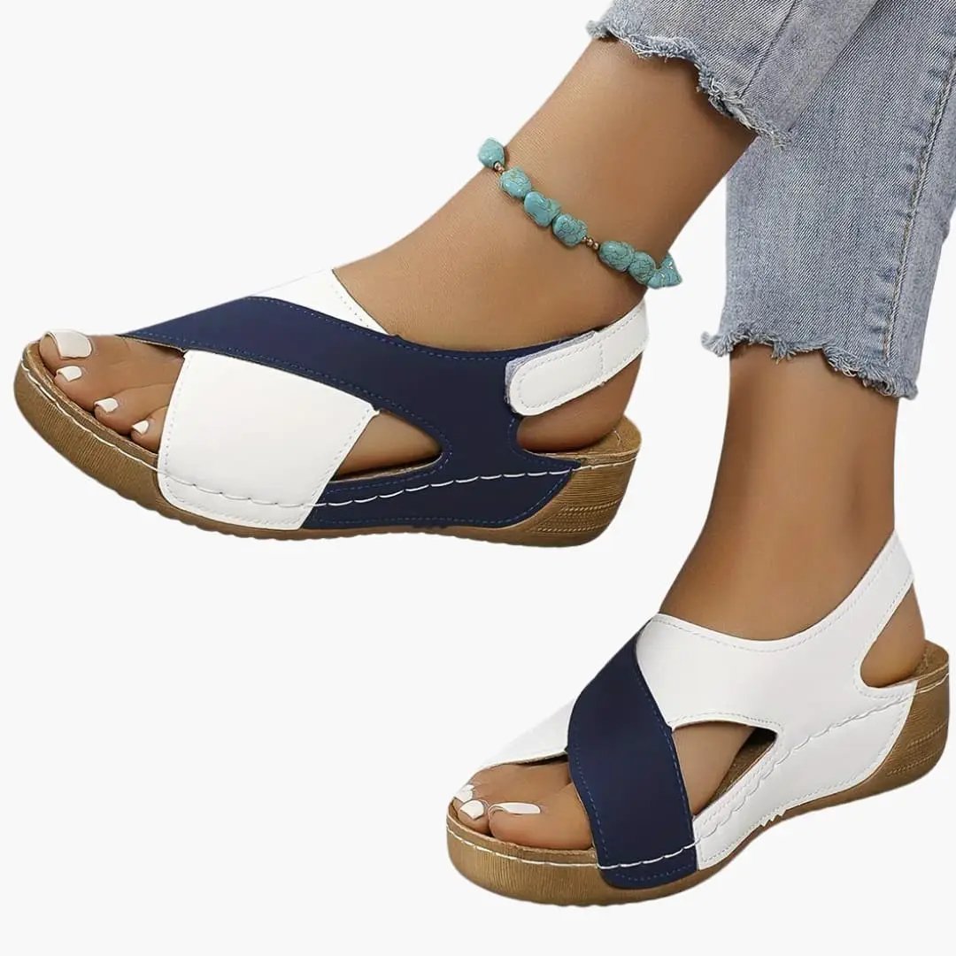 Women's walking sandals by Wilfred Smith; navy and white straps, cushioned insole, adjustable strap.