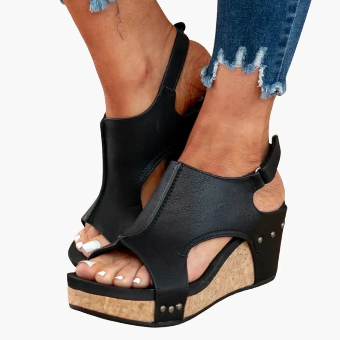 Women's wedge sandals by Wilfred Smith with suede upper and elastic straps, black on cork wedge sole.