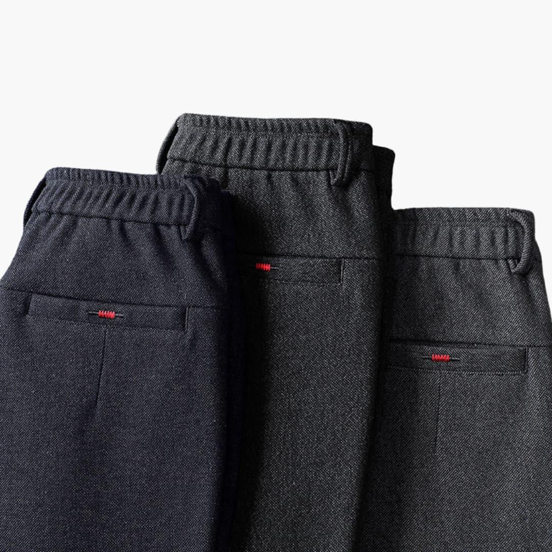 Wilfred Smith men's trousers: three dark charcoal casual pants with elastic waist and red stitching on back pockets
