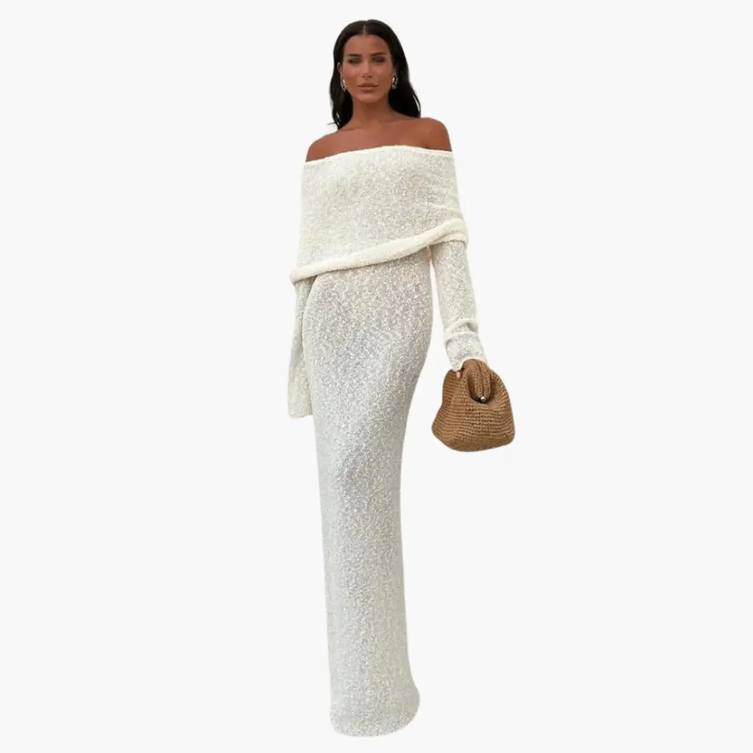 Women's off-shoulder ivory knit maxi dress with textured fabric, paired with a brown woven handbag.