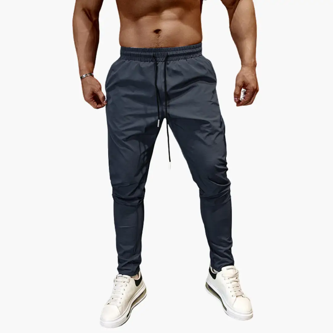 Men's navy jogging pants with elastic waistband and drawstring, tapered fit