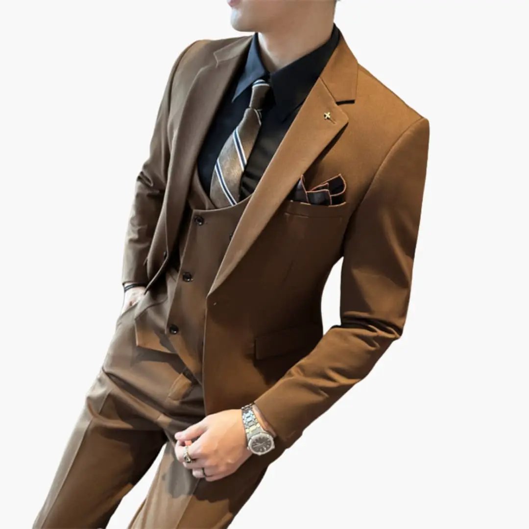 Three-piece Wilfred Smith men's suit in brown with notch lapels, vest, tie, and pocket square.