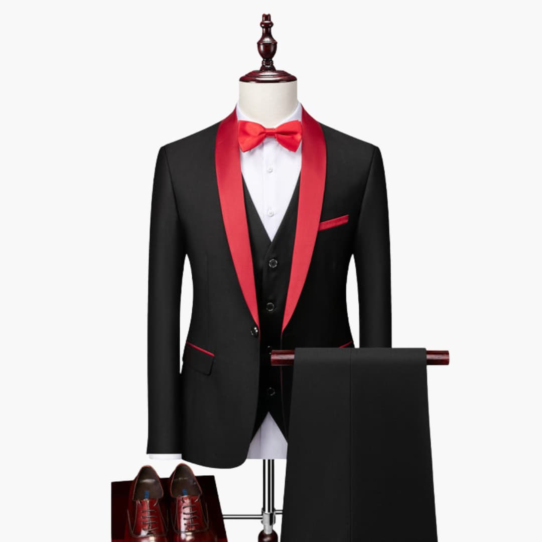 Men's three-piece suit set in black with red satin shawl collar, bow tie, and pocket square by Wilfred Smith