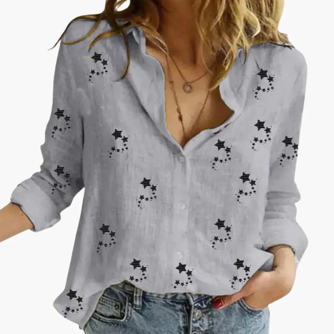 Women's blouse in light grey with black star-pattern, rolled sleeves.