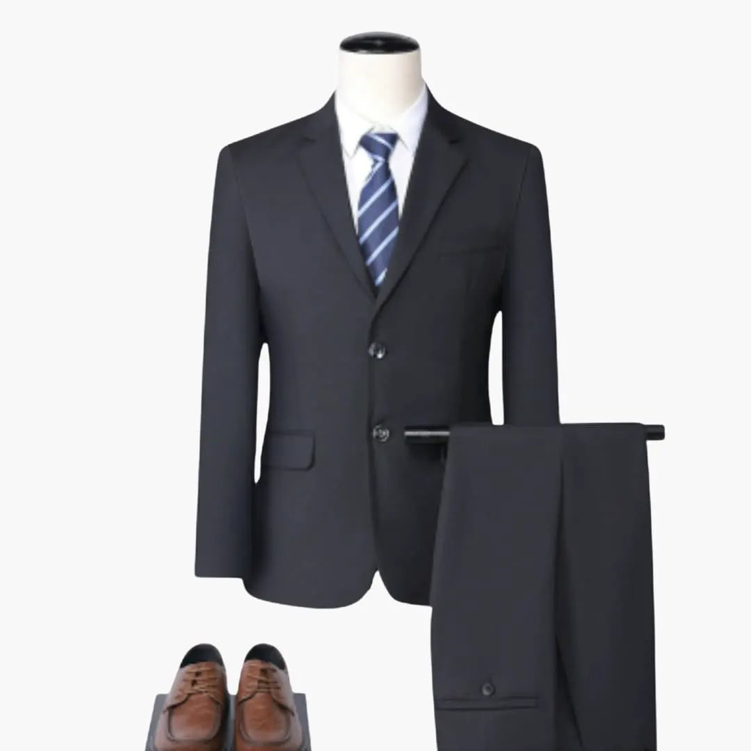 Elegant slim-fit men's suit with jacket, matching pants, blue striped tie, and brown dress shoes