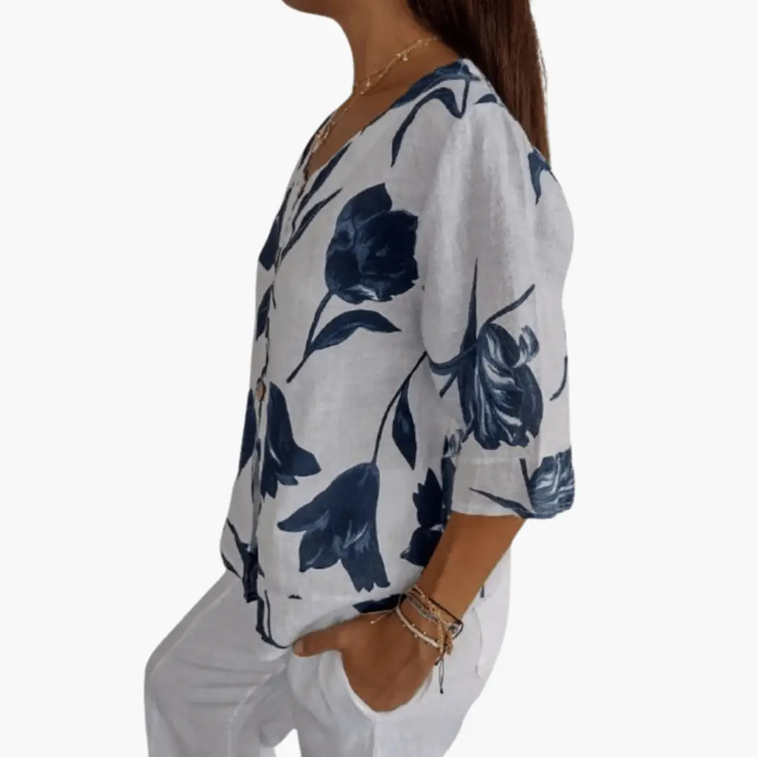 Women's floral print blouse in navy on light gray fabric, V-neck, 3/4 sleeves, loose fit.