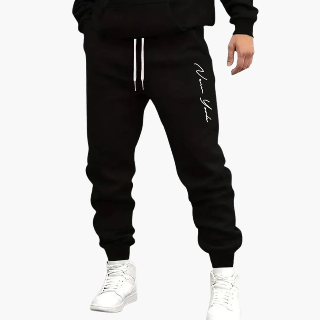 Men's black jogger pants with white drawstrings and cuffed hems