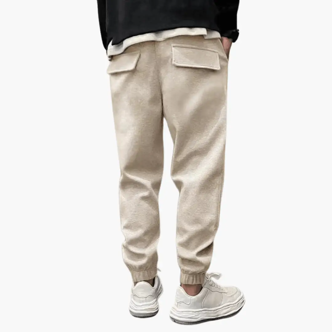 Men’s cargo trousers in beige with relaxed fit, back flap pockets, and cuffed ankles.