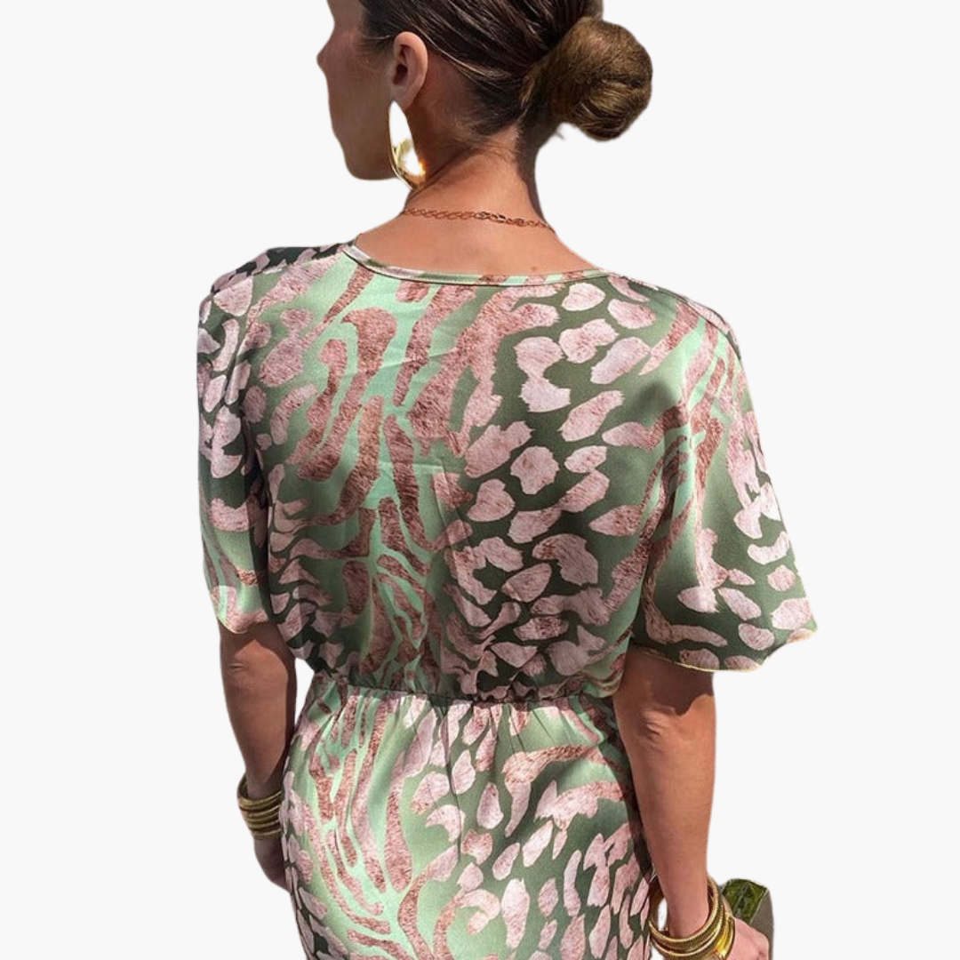 Women's maxi dress with green and pink animal print, short sleeves, elastic waist, back view