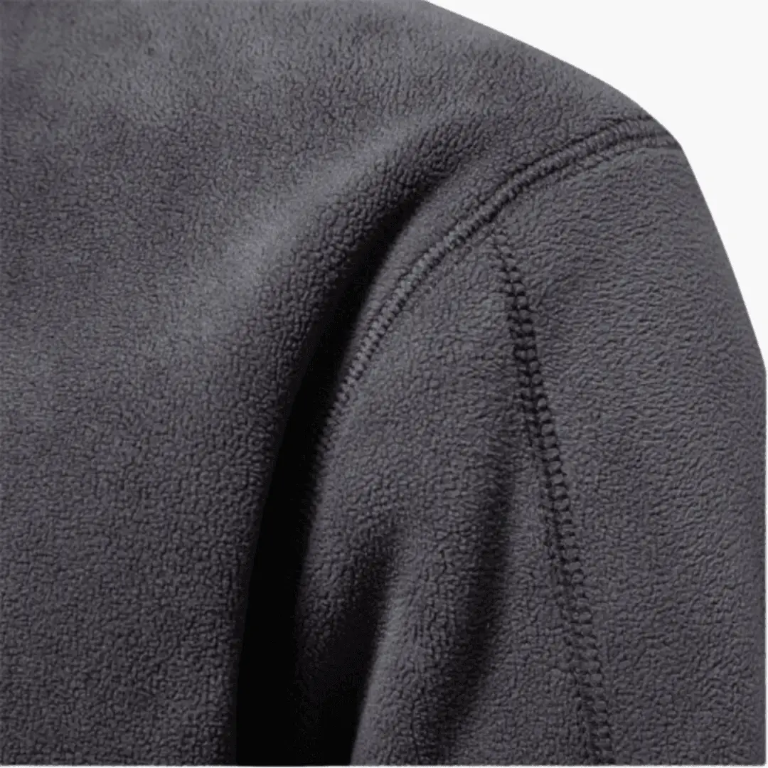 Men’s fleece pullover with half-zip neckline in dark gray textured fleece; shoulder seam detail.