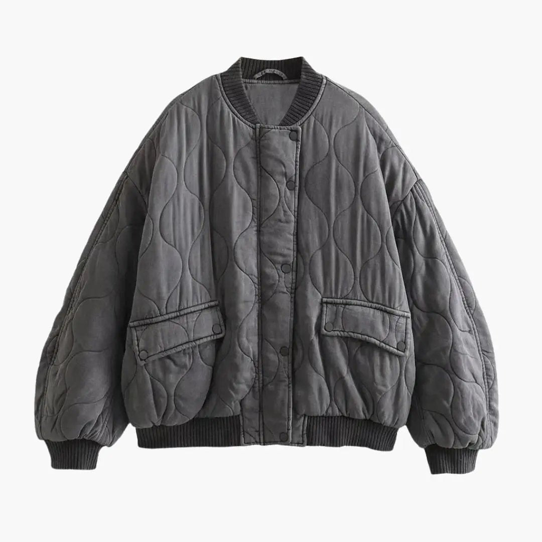 Loose-fit women's bomber jacket in dark gray quilted fabric with ribbed cuffs and hem.