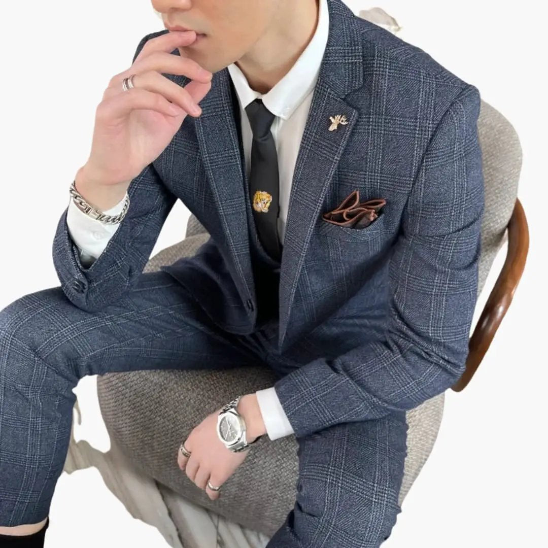 Men's blue checkered three-piece suit set with white shirt, black tie, and pocket square