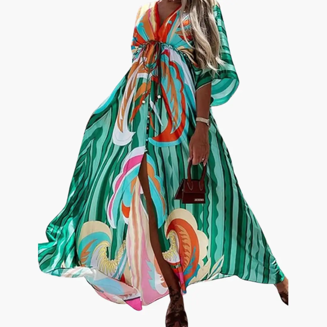 Maxi dress with colorful tropical floral print, waist tie, long flowing silhouette.