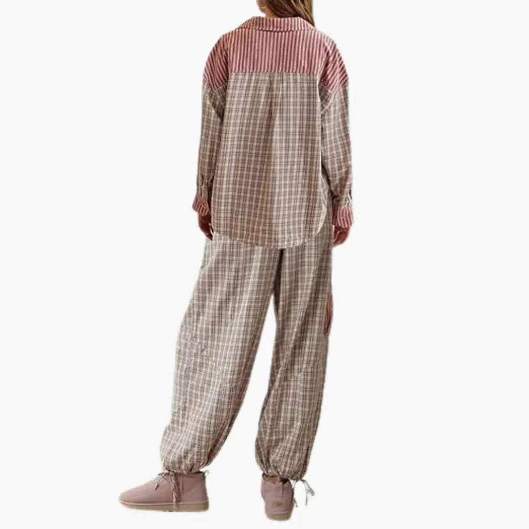 Women's pajama set with striped button-top and elastic plaid pants; pink slippers.
