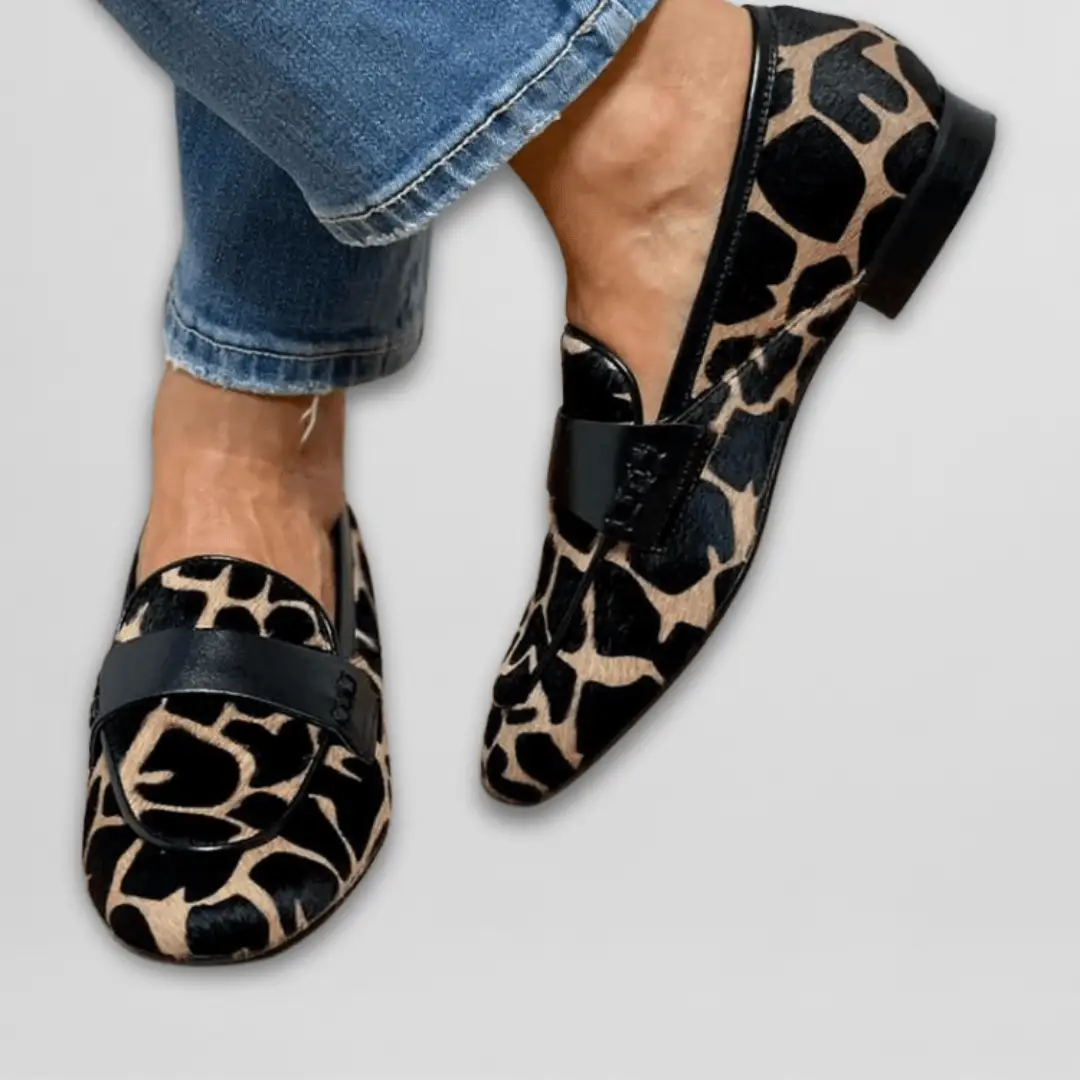 Pair of Wilfred Smith women's orthopedic loafers in leopard print with black strap and cushioned insole