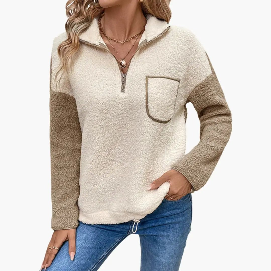 Women's fleece pullover with pocket in cream and tan sherpa; zip-front neckline and chest pocket.