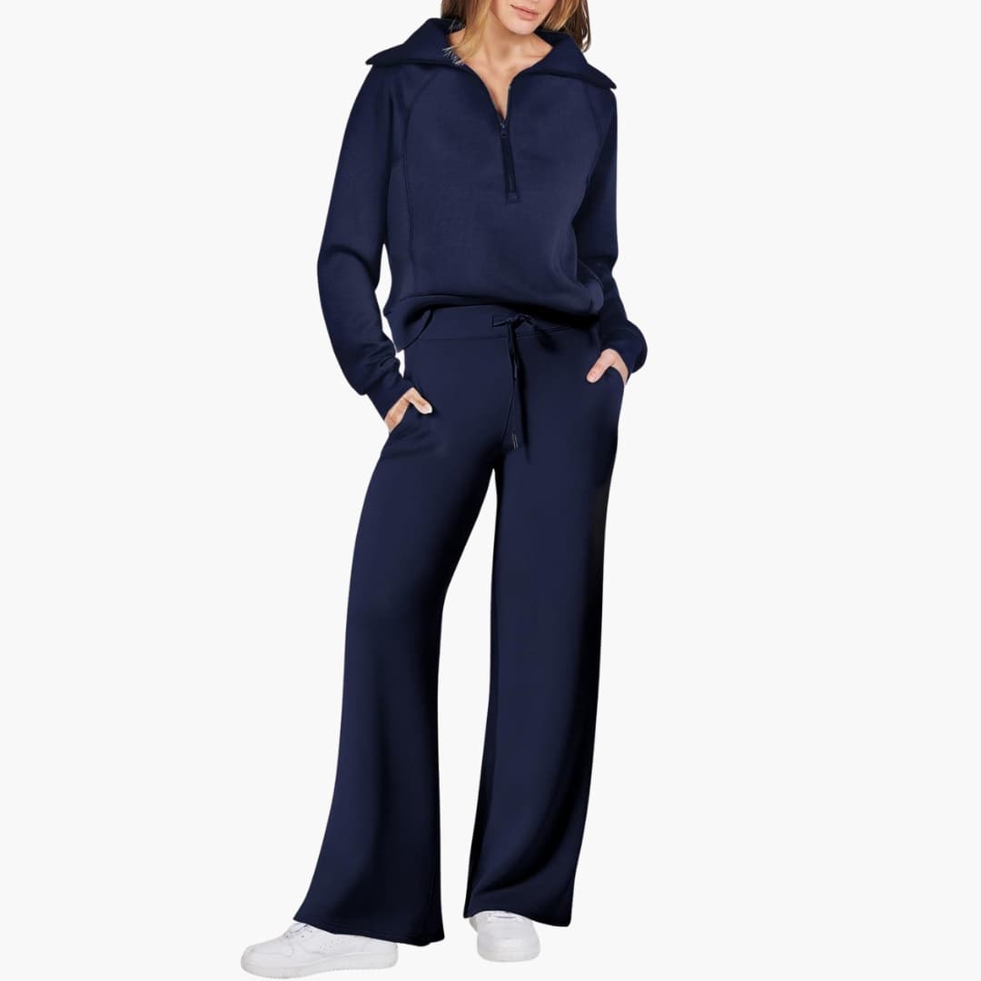 Women's navy lounge set with half-zip top and wide-leg pants, paired with white sneakers