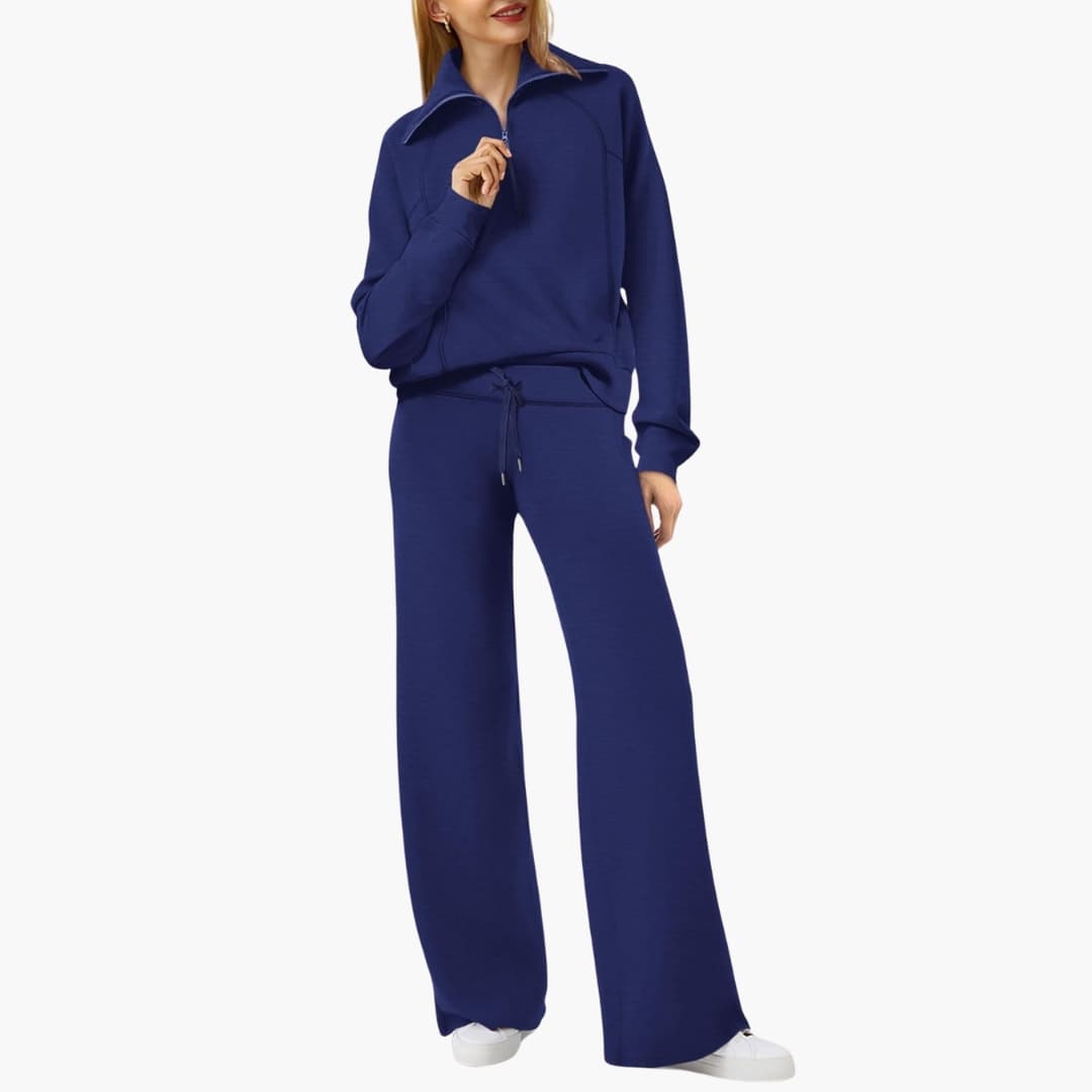 Women's lounge set by Wilfred Smith in navy blue with half-zip top and wide-leg pants.
