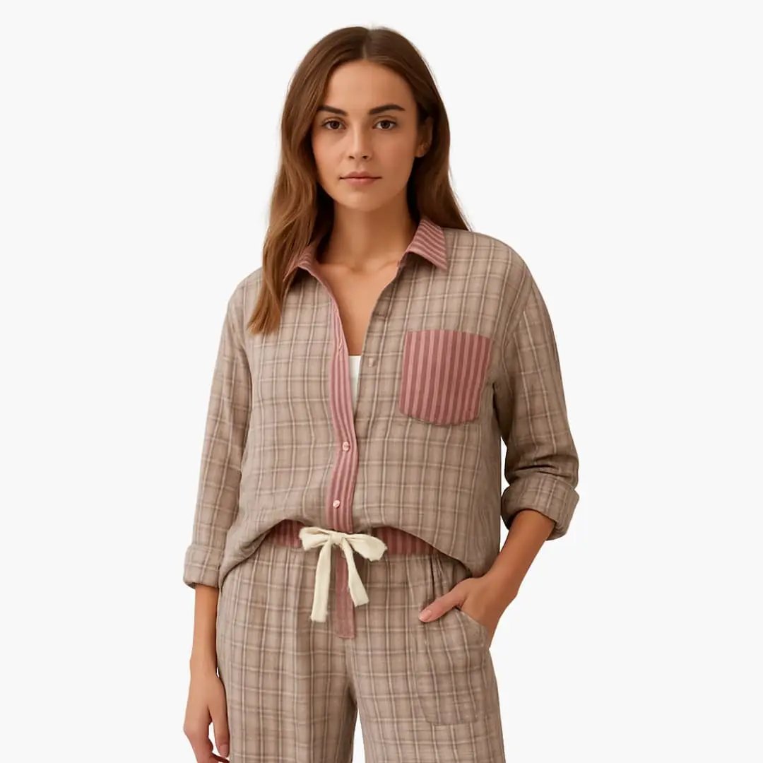 Women's two-piece beige plaid pajama set with pink striped accents, button-front top and drawstring pants.