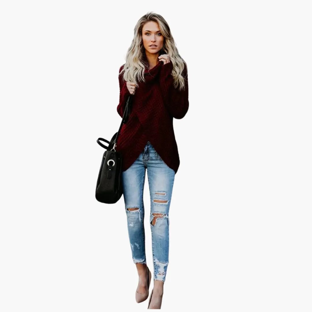 Women's knit sweater with shawl collar in burgundy, paired with distressed jeans and a black handbag.