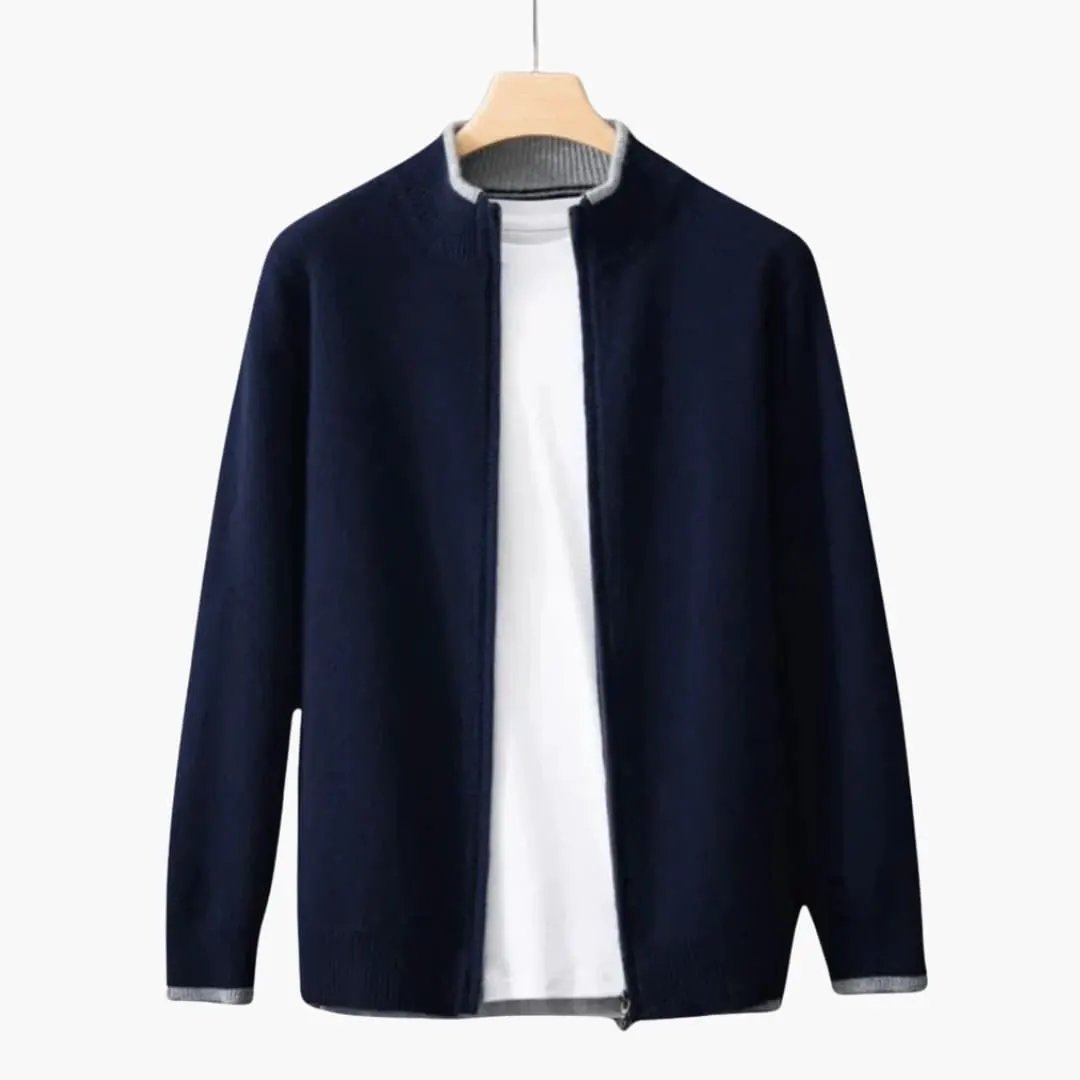 Men's navy zip-up cardigan with open front zipper, ribbed grey collar and cuffs, by Wilfred Smith on a wooden hanger