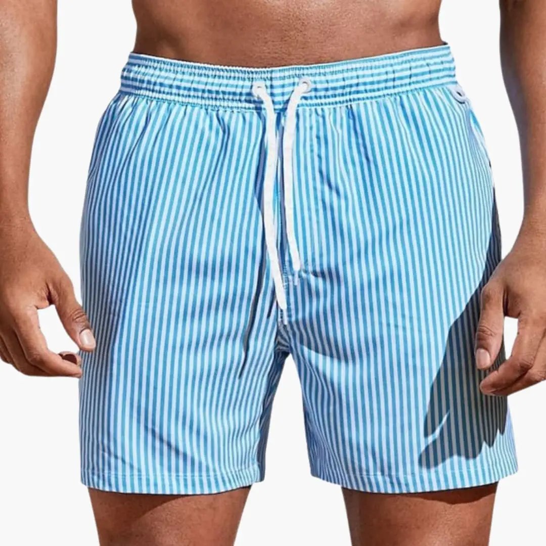 Men’s board shorts by Wilfred Smith with blue and white vertical stripes, elastic waistband and drawstring.